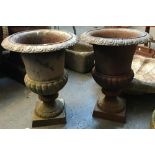A pair of cast iron garden urns, 40cmH