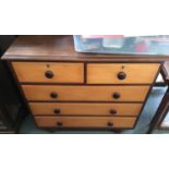 A modern stained pine chest of two short over three long drawers, on bun feet, 91cmW
