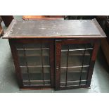 An early 19th century mahogany glazed wall cupboard, with two shelves, 93cmW