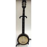A five string banjo by JE Dallas, in soft case