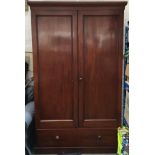 A large 19th century mahogany wardrobe, two cupboard doors with hanging rail, above a single drawer,