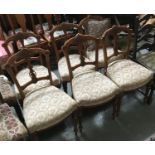 A set of six French dining chairs, foliate and rosette carved top rail, narrow carved splat