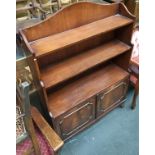 A 20th century mahogany veneer waterfall bookcase, with two cupboard doors below, 83cmW