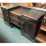 An early 20th century oak sideboard, two drawers flanked by two carved cupboard doors, 137cmW