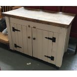 A large modern sideboard, three plank top over two painted cupboard doors, 125x64x91.5cmH