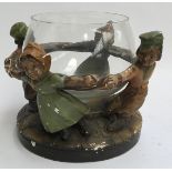A Dutch table centrepiece, in the form of boy and girl figurines holding hands, around a glass bowl