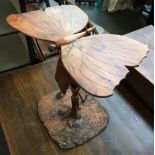 An unusual carved side table, in the form of a butterfly over a lily, 50cmH