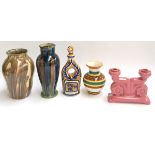 Three vases, one Quimper, a majollica 'eau de vie' bottle, and a pink ceramic candleholder