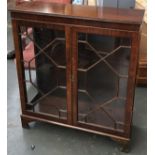 An astragal glazed bookcase with three glass shelves, with key, on bracket feet, 92.5cmW