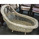 A painted wicker rocking cradle