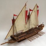 A scratch built wooden model of a Japanese war ship, fully rigged with 42 oars, 99cm long