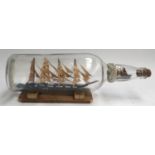 A model of a tall ship in a bottle, with a smaller model in the neck, 51cmL