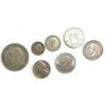 A collection of five silver coins, to include a 1918 one shilling; a 1928 sixpence; a 1933 half