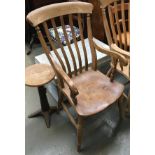 A lathe back kitchen chair, scrolled arms on turned supports, shaped elm seat, on baluster turned