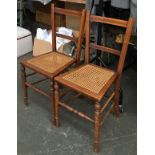 A pair of early 20th century occasional chairs, with caned seats