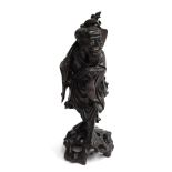 A large detailed Chinese hardwood carving of a fisherman with basket and fish, 35cmH