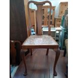 An Edwardian caned mahogany occasional chair, with shell carved cabrioles