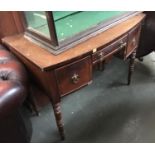 A 19th century mahogany kneehole desk/dressing table, bow front, three drawers, on turned legs,