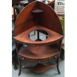 A George III mahogany corner washstand, undershelf with single drawer flanked by two blind