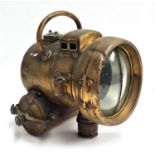 An Edwardian brass self-generating acetylene head lamp, bears warning 'empty water out