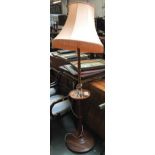 A mahogany turned standard lamp, with turned shelf, and shade