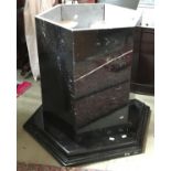 A hexagonal black marble table base