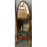 An oval cheval mirror with bevelled glass, 132cmH
