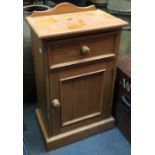 A pine bedside cabinet with single drawer over cupboard, 43cmW; together with a wicker laundry