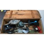 A vintage wooden box containing a variety of items including several masons mallets