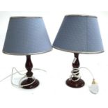 A pair of wooden turned table lamps, with shades