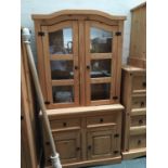 A modern pine glazed dresser, shelves over two short drawers over cupboard doors, 104x47x198cmH