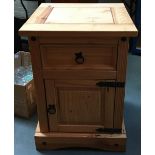 A modern pine bedside table, single drawer over cupboard door