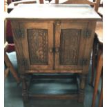 A small oak cupboard with carved doors, 51x32x68cmH