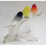A studio glass figure group of three songbirds on a branch, signed indistinctly, 22cm high