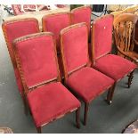 A set of six red suede covered dining chairs