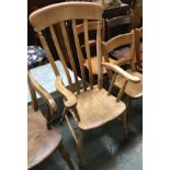 A lathe back kitchen chair, outswept arms on turned supports, on ring and baluster turned legs