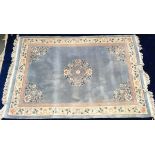 A Chinese blue wool rug with central motif, 180x275cm