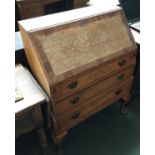 A small 20th century bureau, fall front above three graduating drawers, on carved cabriole legs,
