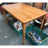 A light oak kitchen table, on turned tapering legs