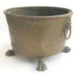 A 19th century copper coal bucket, with liner, with rivetted repair, lion mask hoop handles, on four