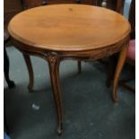 A Continental circular table, the later top above a frieze with floral and foliate carving, on