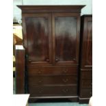A 19th century mahogany linen press, the top with four slides, over a base of three drawers, on