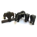 A pair of hardwood carved elephant bookends, pair of carved elephant figurines, and a carved