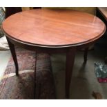 A circular hardwood dining table