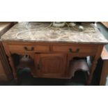 A marble topped side table, one corner cracked, 107cmW