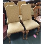 A set of four 20th century dining chairs, upholstered backs and stuffover seats, on carved