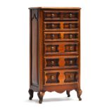 A miniature stained hardwood chest of six graduating drawers, on cabriole legs, 38.5cm high