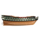 A wooden model of an 18th century ship, the hull made from small individual planks, 81cmL