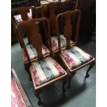 A set of four 20th century oak splat back dining chairs with drop in seats, on cabriole legs