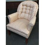 A good button back salon chair, with outward scrolling arms, on square tapered legs